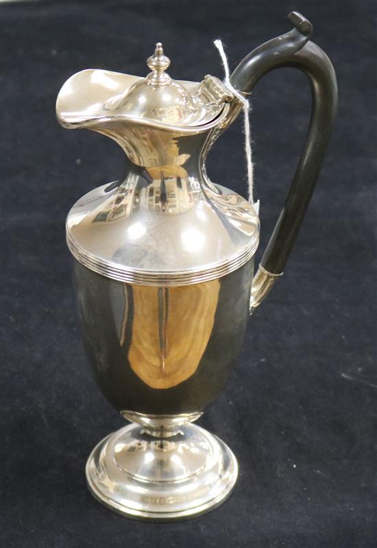 A silver urn-shaped hot water jug, the ebonised handle with acanthus terminals, London 1915, Horace Woodward & Co Ltd, 14oz